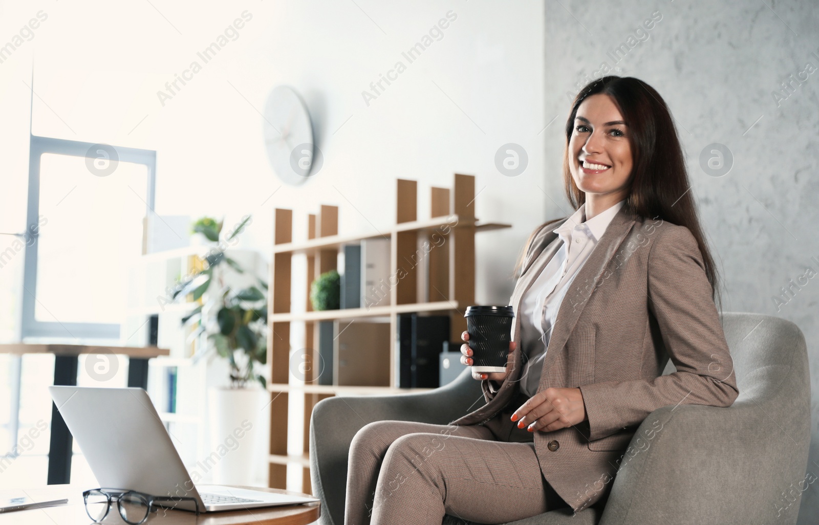 Photo of Female business trainer working with laptop in office