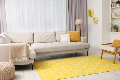 Spring atmosphere. Stylish room interior with comfy sofa, lamp, ottoman and armchair