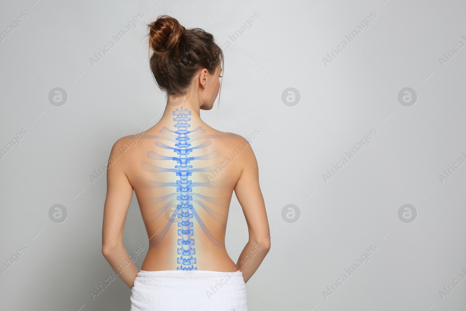 Image of Woman with healthy spine on light background, back view. Space for text