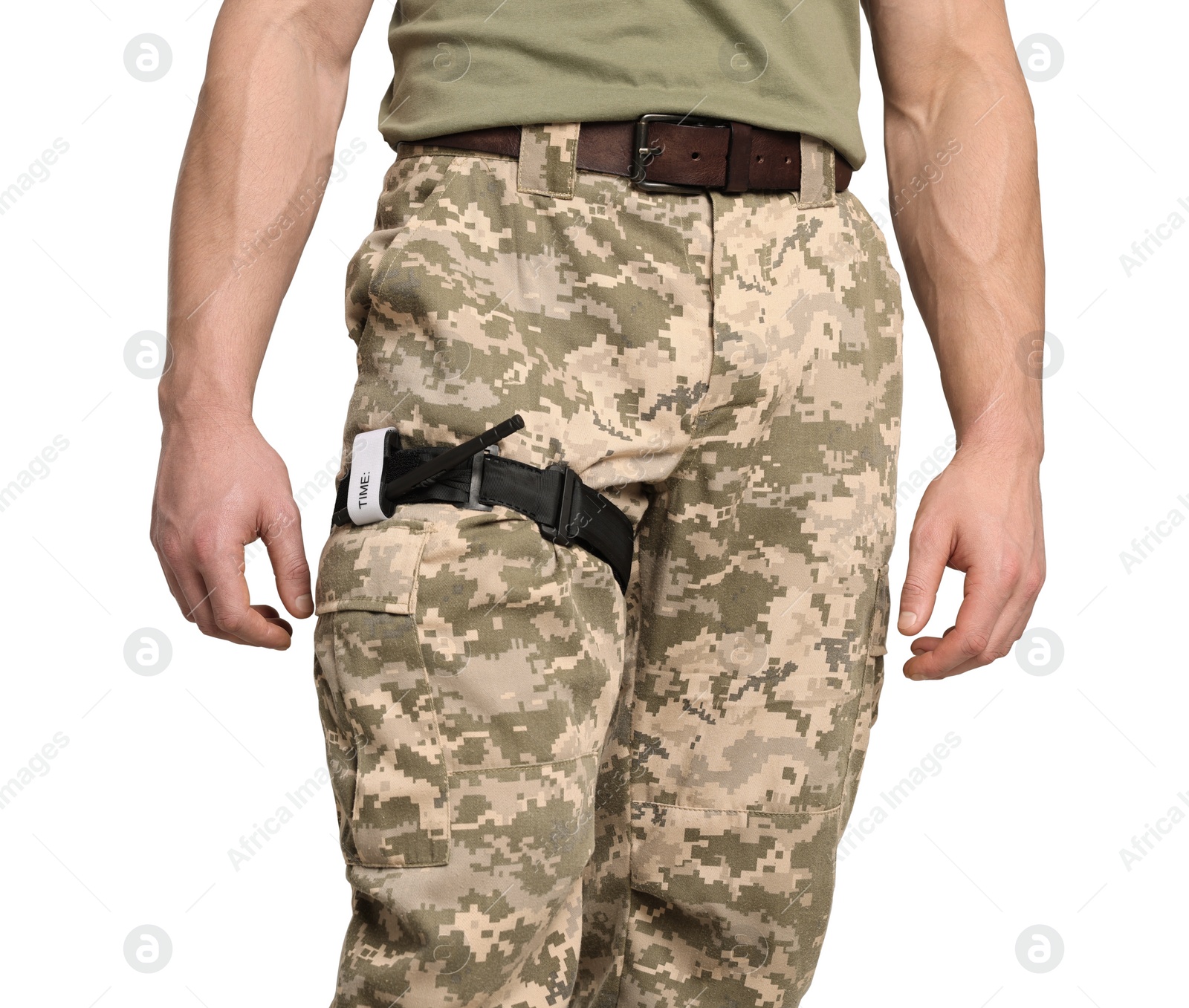 Photo of Soldier in military uniform with medical tourniquet on leg against light grey background, closeup. Space for text