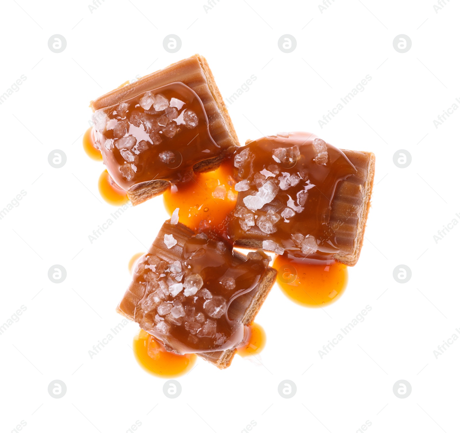 Photo of Delicious salted caramel with sauce on white background, top view