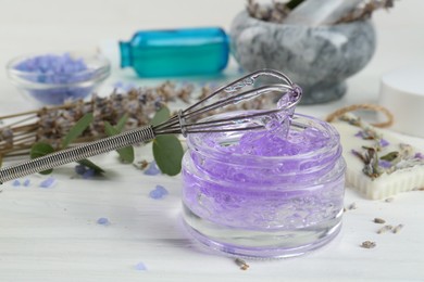 Photo of Homemade lavender gel and whisk on white wooden table, closeup