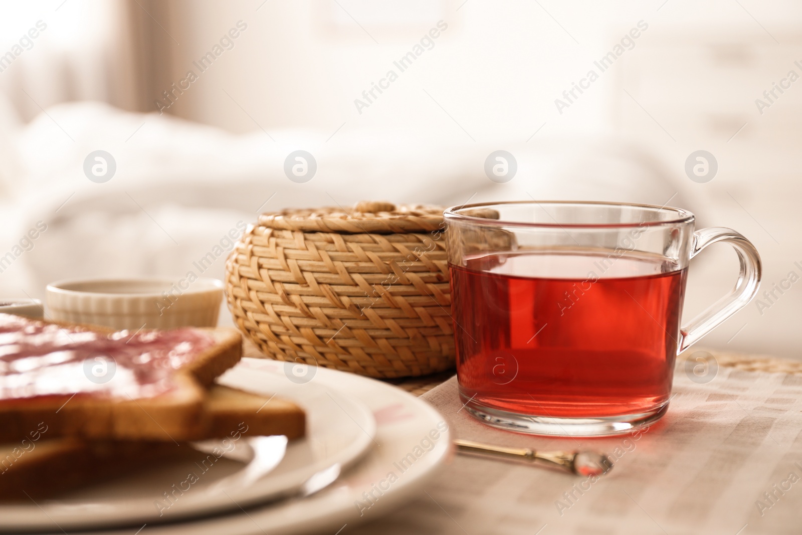 Photo of Toasts and tea on table indoors. Delicious morning meal