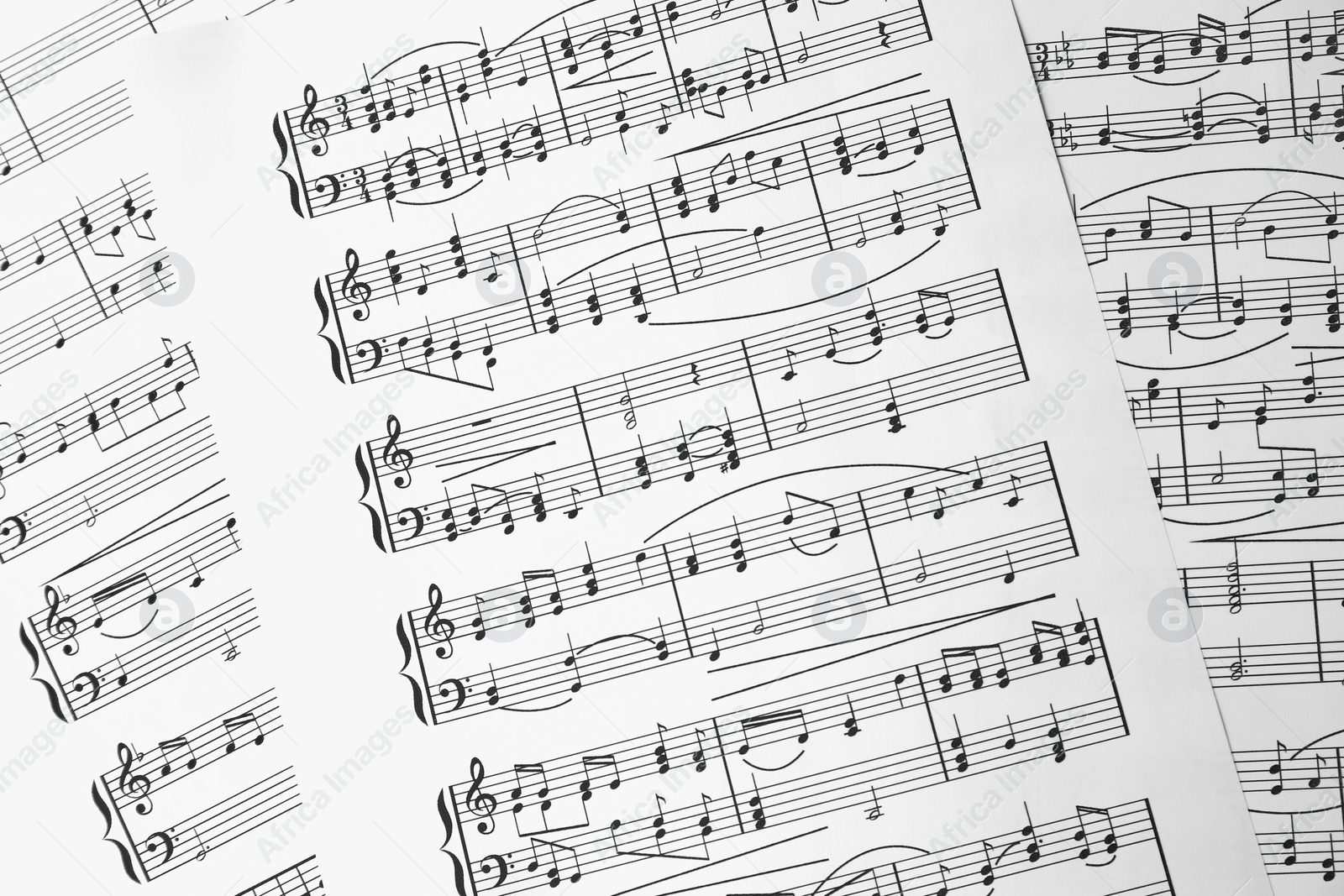 Photo of Music sheets. Melodies written with different musical symbols as background, closeup