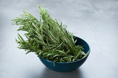 Bunch of fresh rosemary on grey table