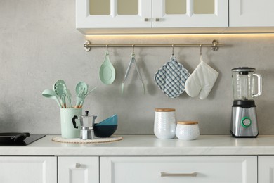 Photo of Set of different utensils and dishes on countertop in kitchen