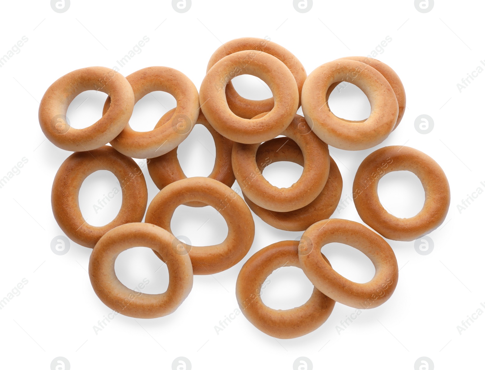 Photo of Many tasty dry bagels (sushki) isolated on white, top view