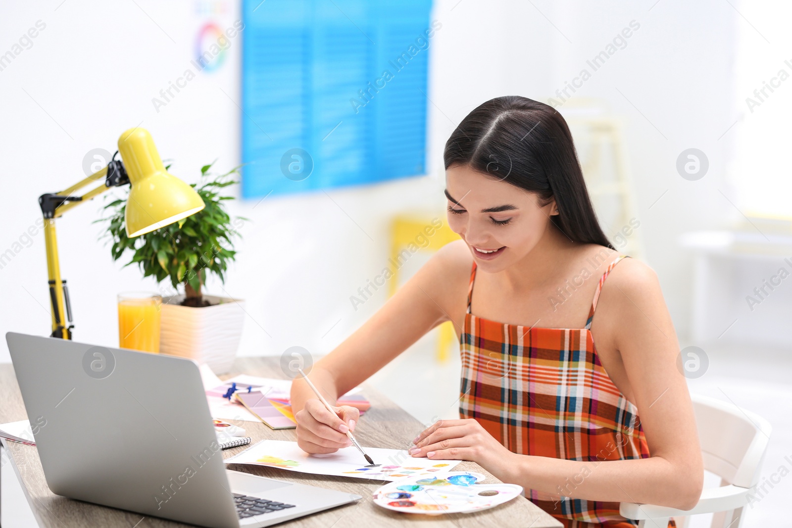 Photo of Female designer working at desk in office