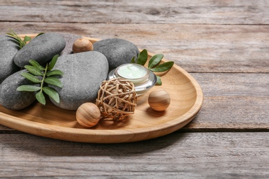 Composition with spa stones on wooden table