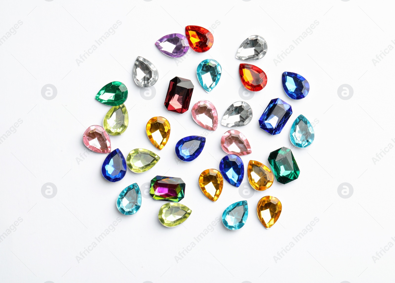 Image of Different beautiful gemstones on white background, top view