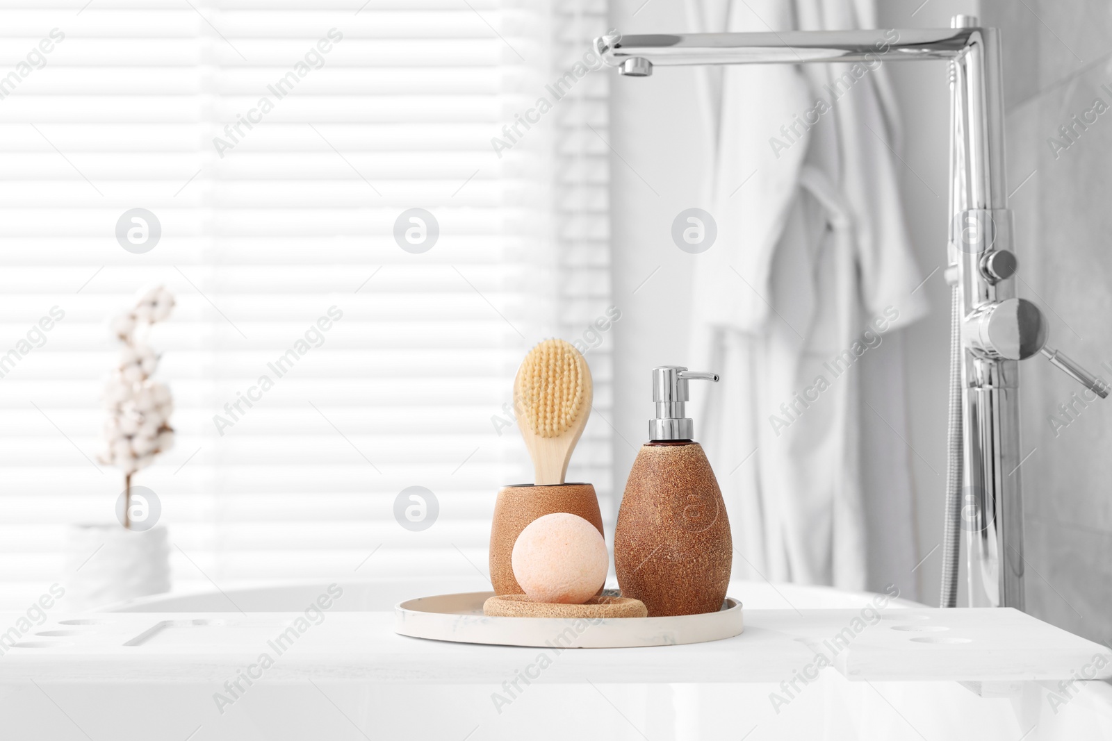 Photo of Different personal care products and accessories on bath tub in bathroom