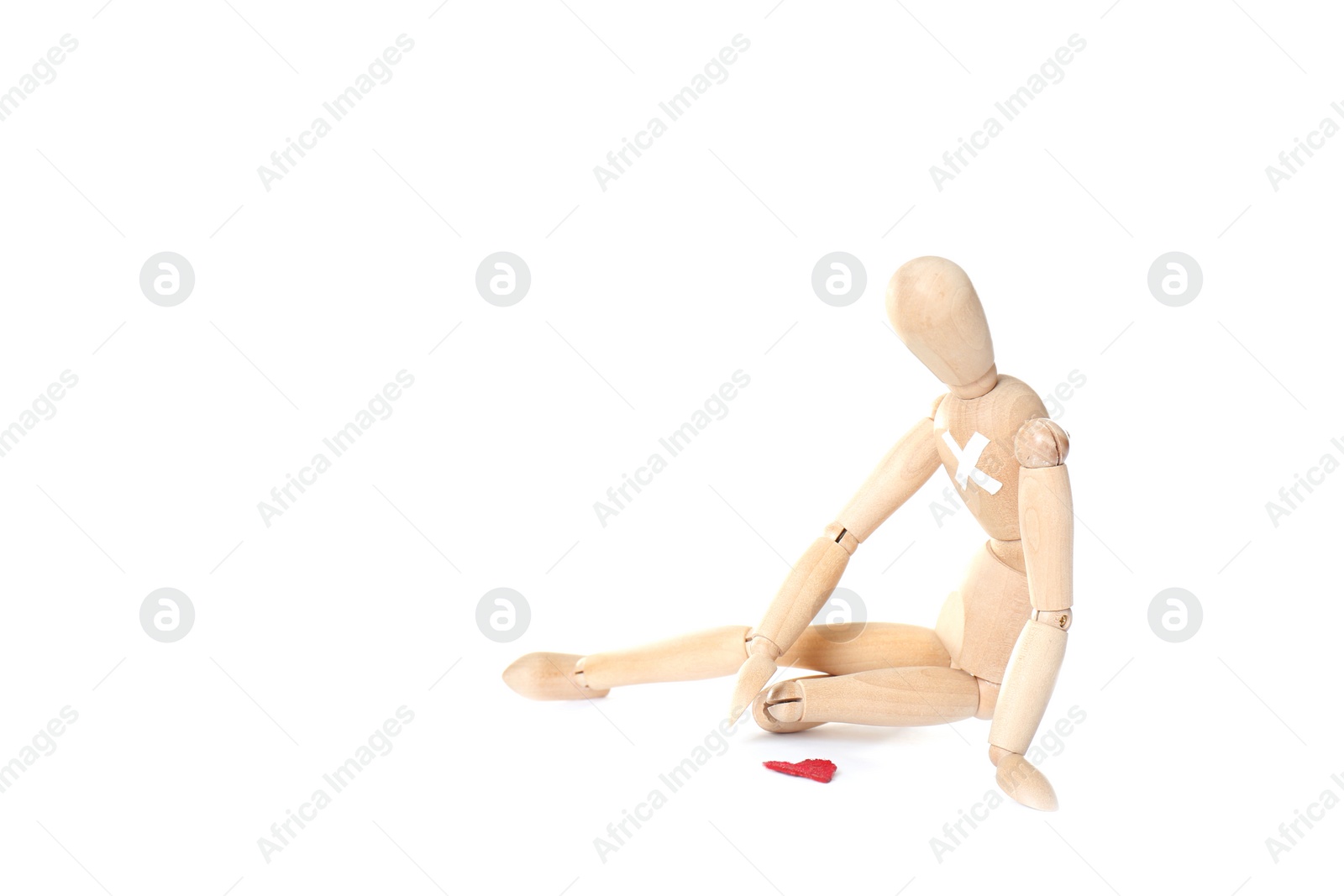 Photo of Wooden puppet with small heart on white background. Relationship problems