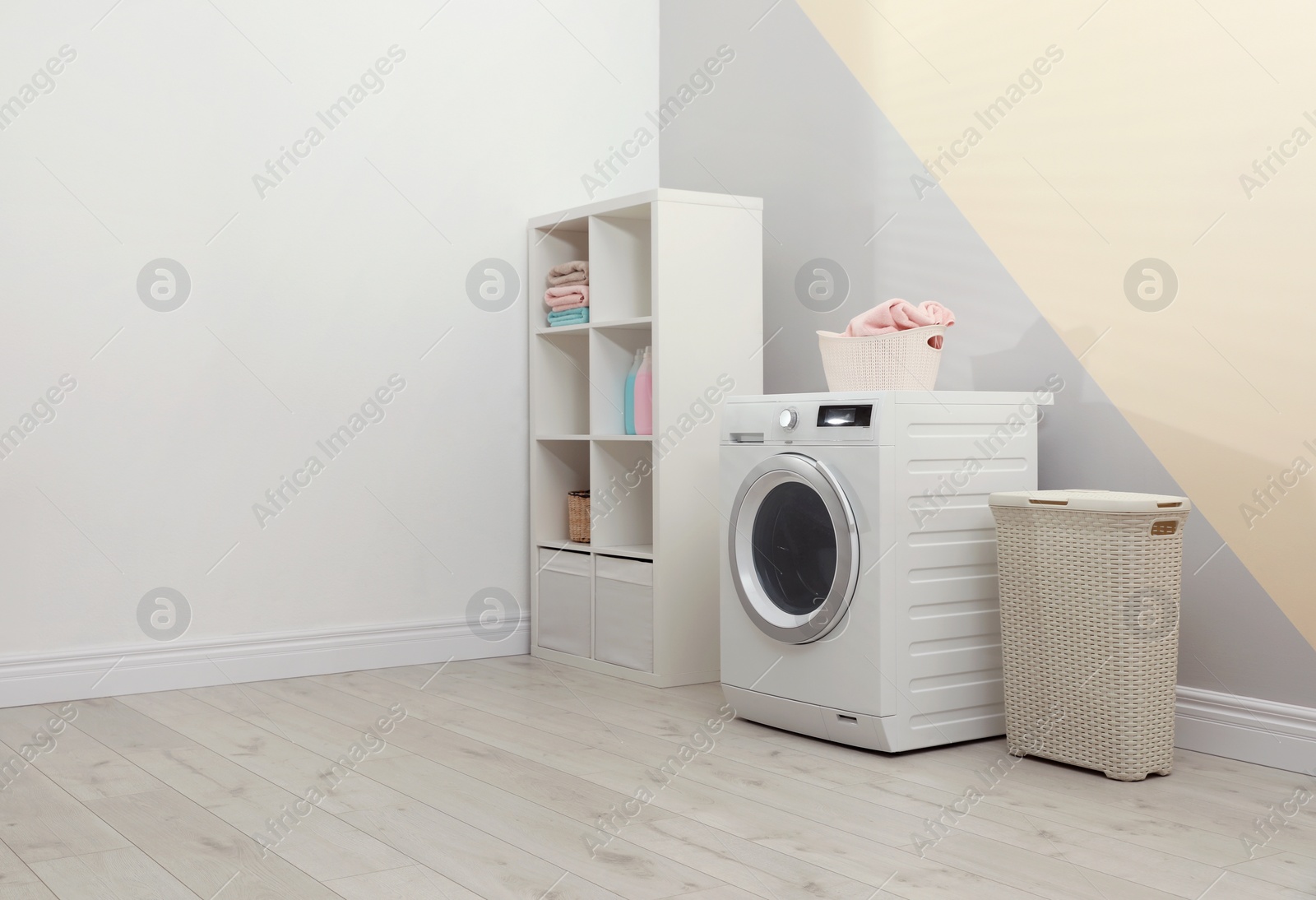 Photo of Modern washing machine in laundry room interior. Space for design