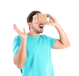 Photo of Young man using cardboard virtual reality headset, isolated on white