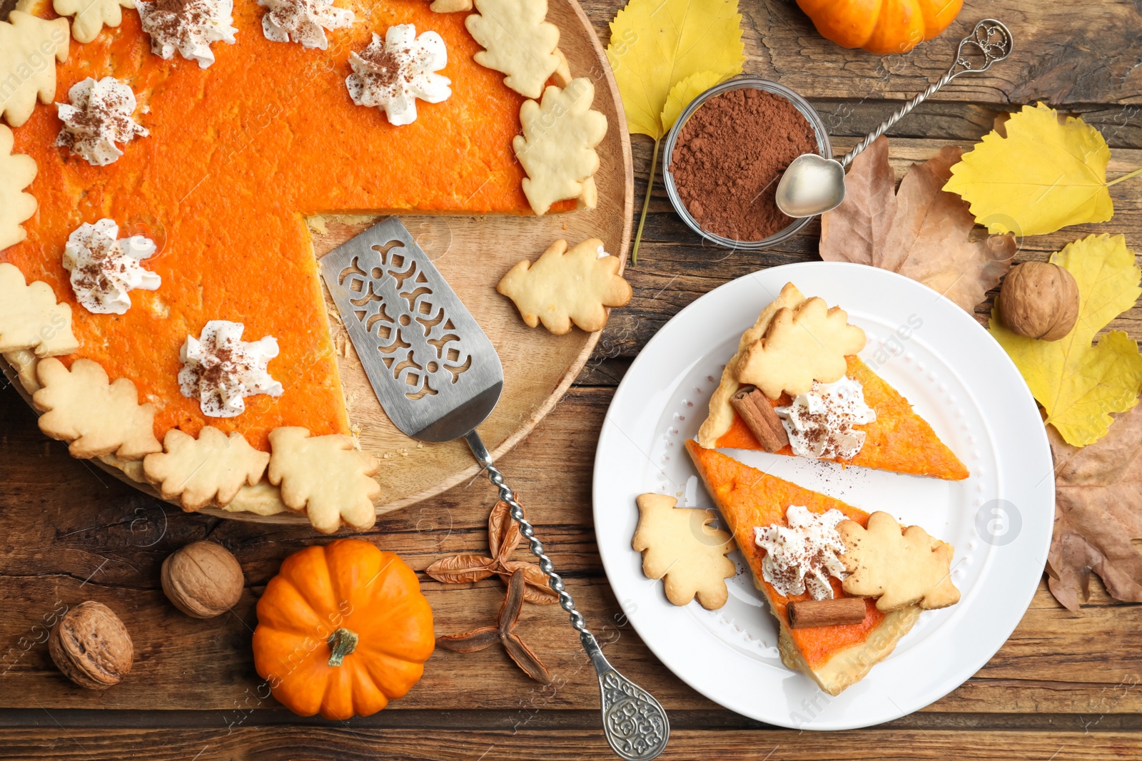 Photo of Delicious homemade pumpkin pie on wooden table, flat lay