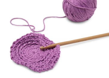 Photo of Soft violet woolen yarn, knitting and crochet hook on white background, closeup