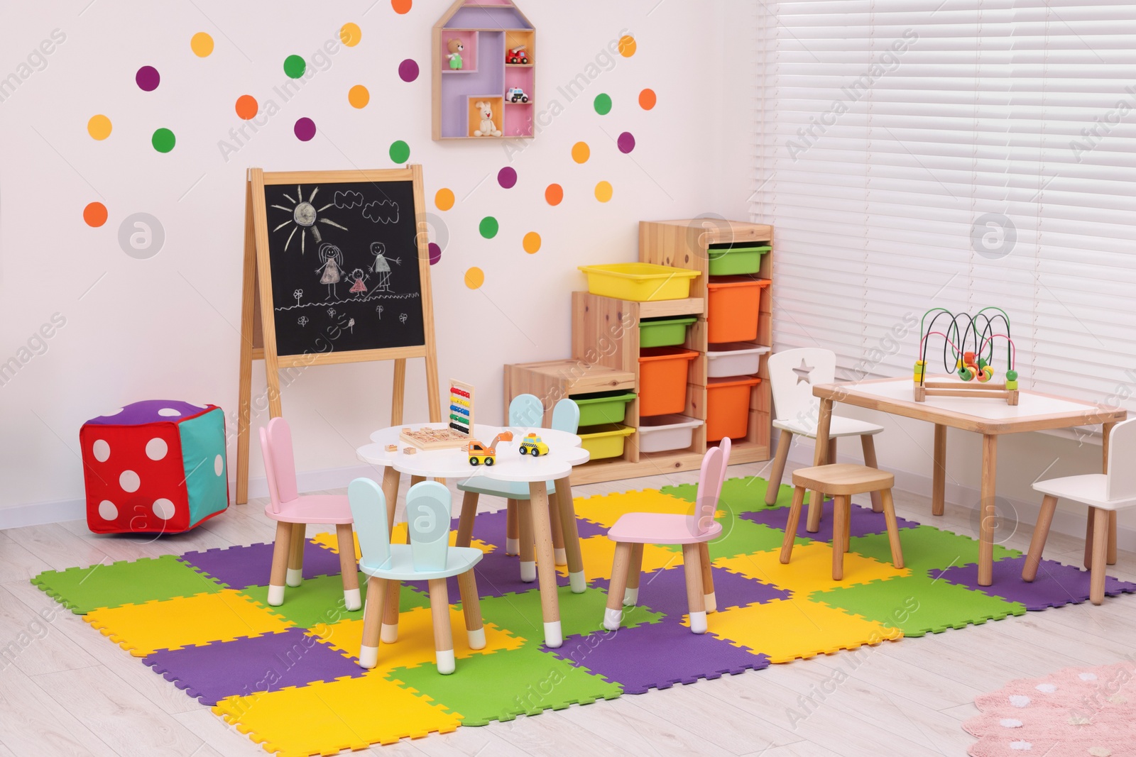 Photo of Stylish kindergarten interior with toys and modern furniture