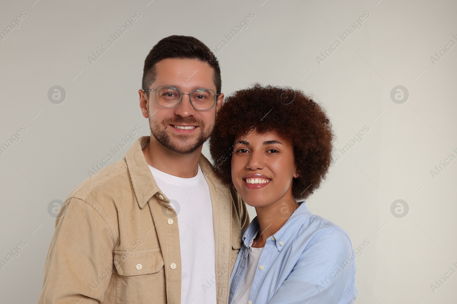 Photo of International dating. Portrait of happy couple on light grey background