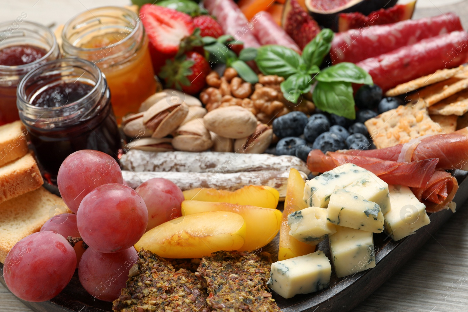 Photo of Many different tasty appetizers on table, closeup