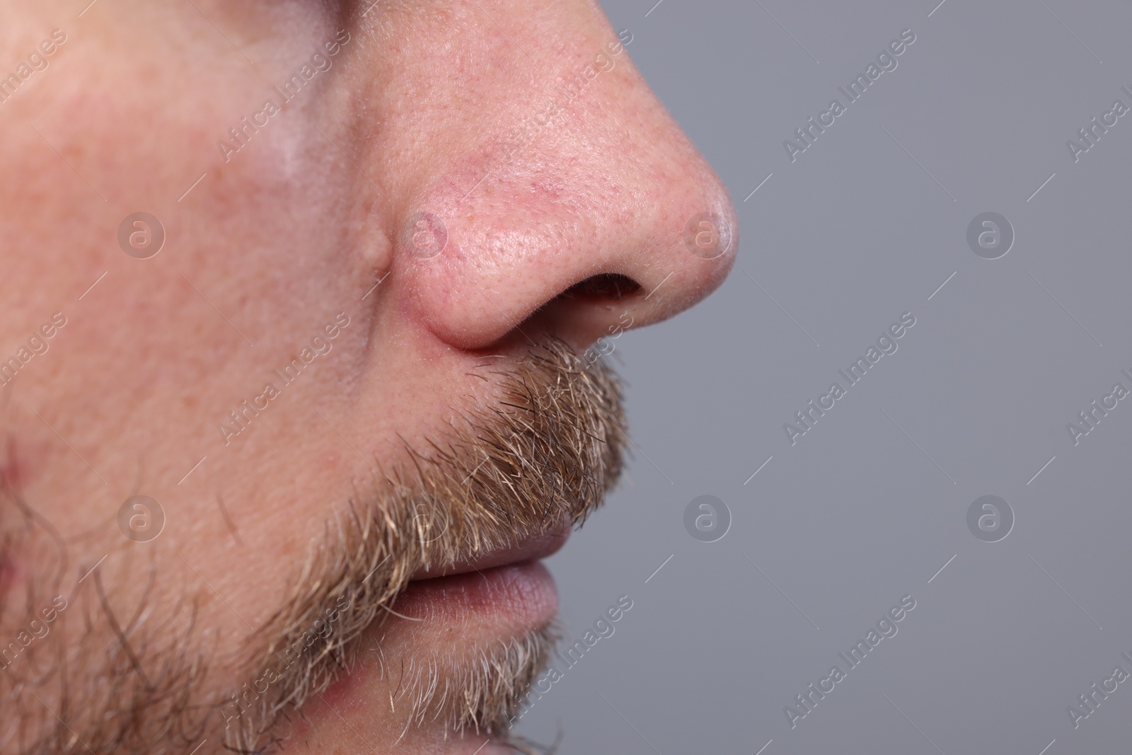 Photo of Closeup view of man with normal skin on grey background, space for text