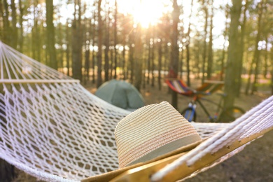 Hammock with hat in forest on summer day