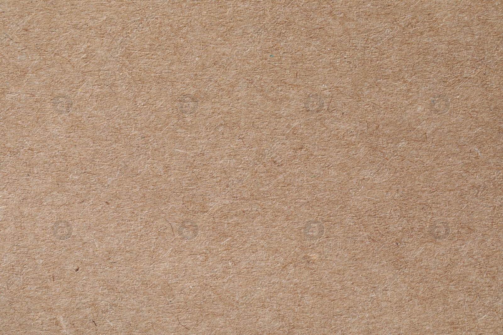 Photo of Texture of kraft paper sheet as background, closeup