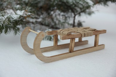 Beautiful decorative wooden sleigh on snow outdoors