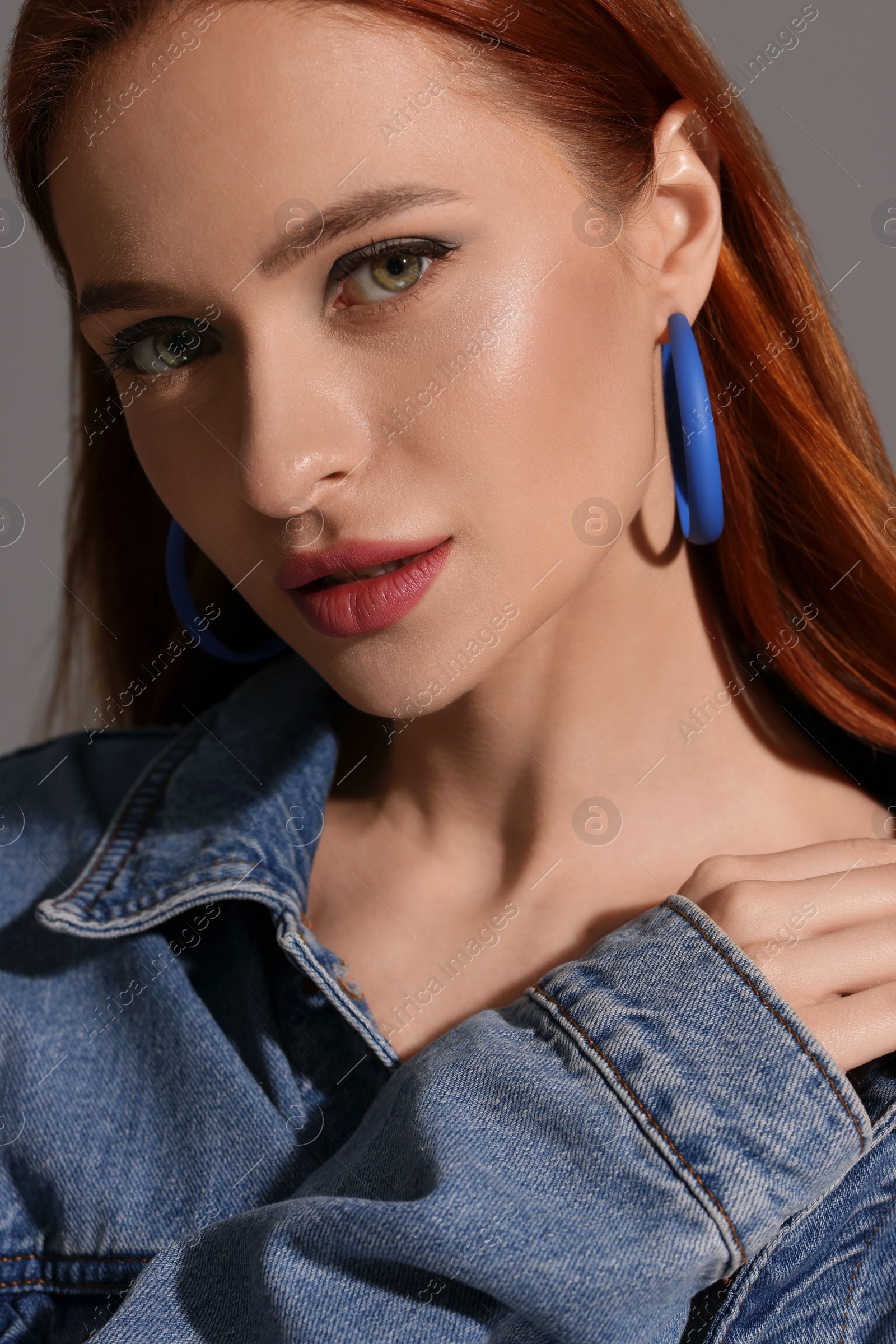 Photo of Beautiful young woman in denim jacket, closeup