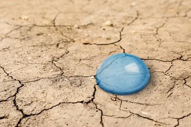 Image of Save environment. Water drop on dry cracked land, closeup
