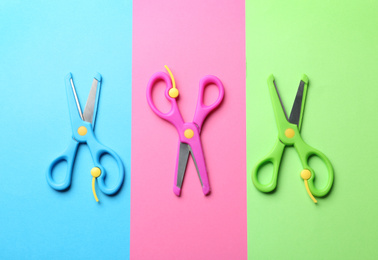 Bright scissors on color background, flat lay