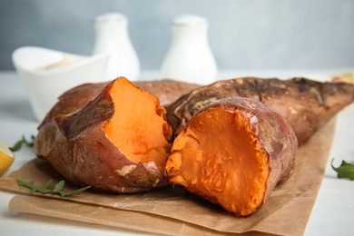 Photo of Delicious baked sweet potatoes on table, closeup