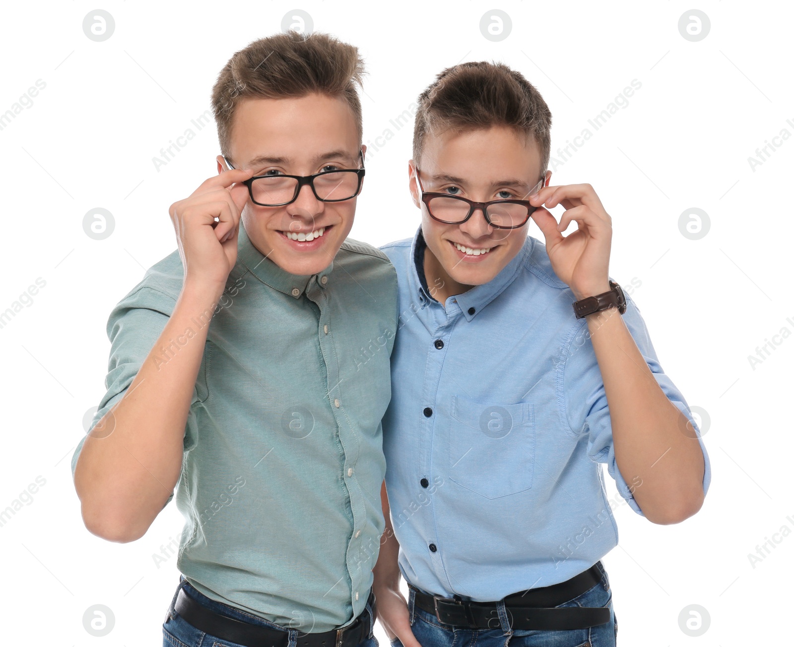 Photo of Teenage twin brothers with glasses on white background