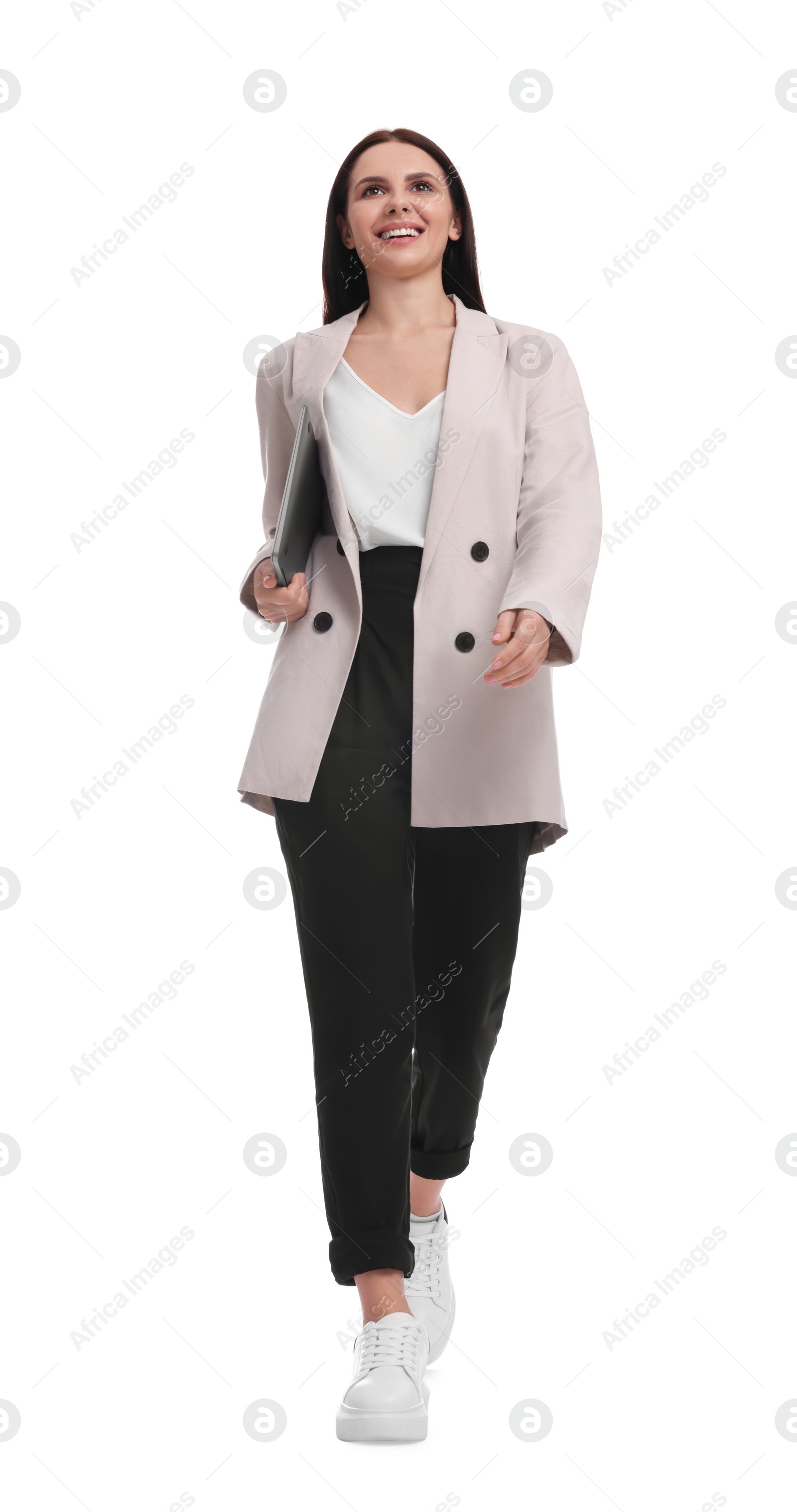 Photo of Beautiful businesswoman in suit with laptop walking on white background