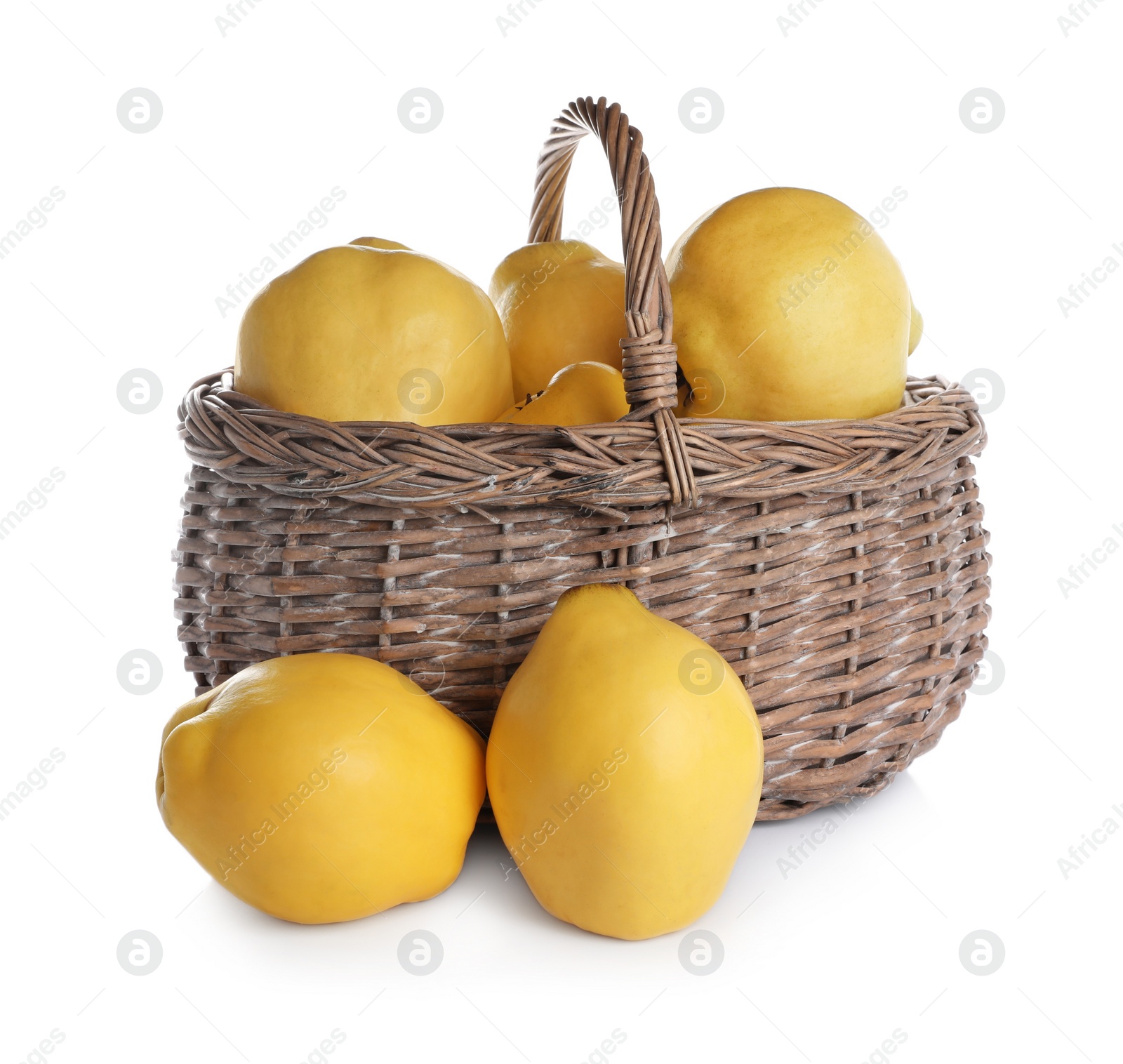 Photo of Ripe quinces in wicker basket on white background