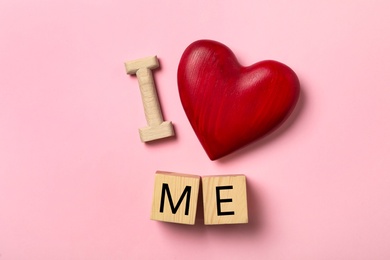 Photo of Phrase I Love Me with red heart on pink background, flat lay