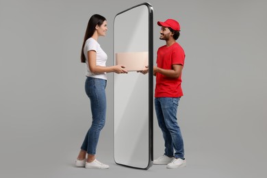 Image of Courier delivering parcel to woman through huge smartphone on grey background