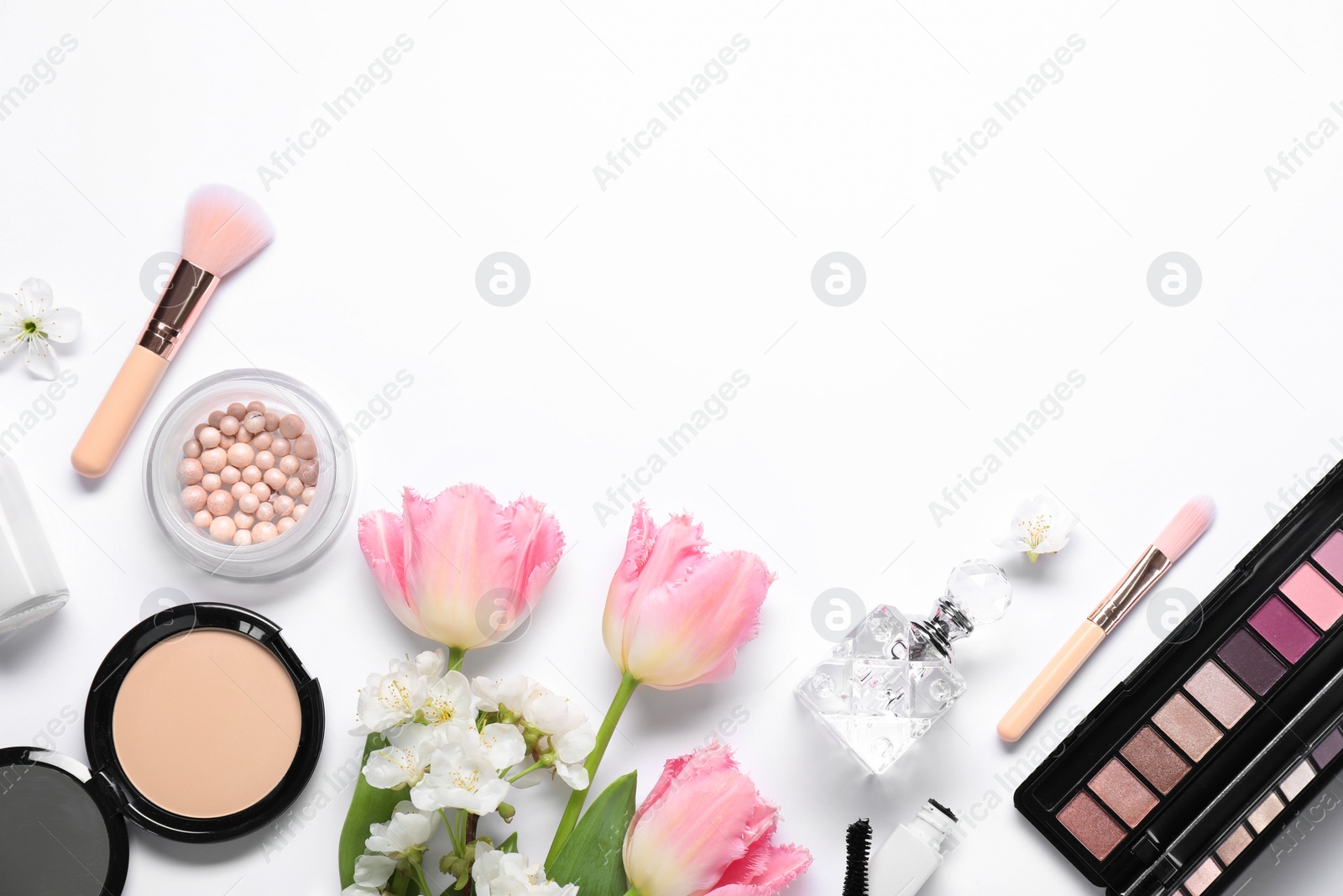 Photo of Flat lay composition with different makeup products and beautiful spring flowers on white background, space for text