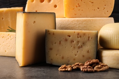 Different types of delicious cheese on table, closeup