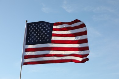 Photo of American flag fluttering outdoors on sunny day