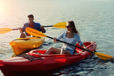 Couple kayaking on river in evening. Summer activity