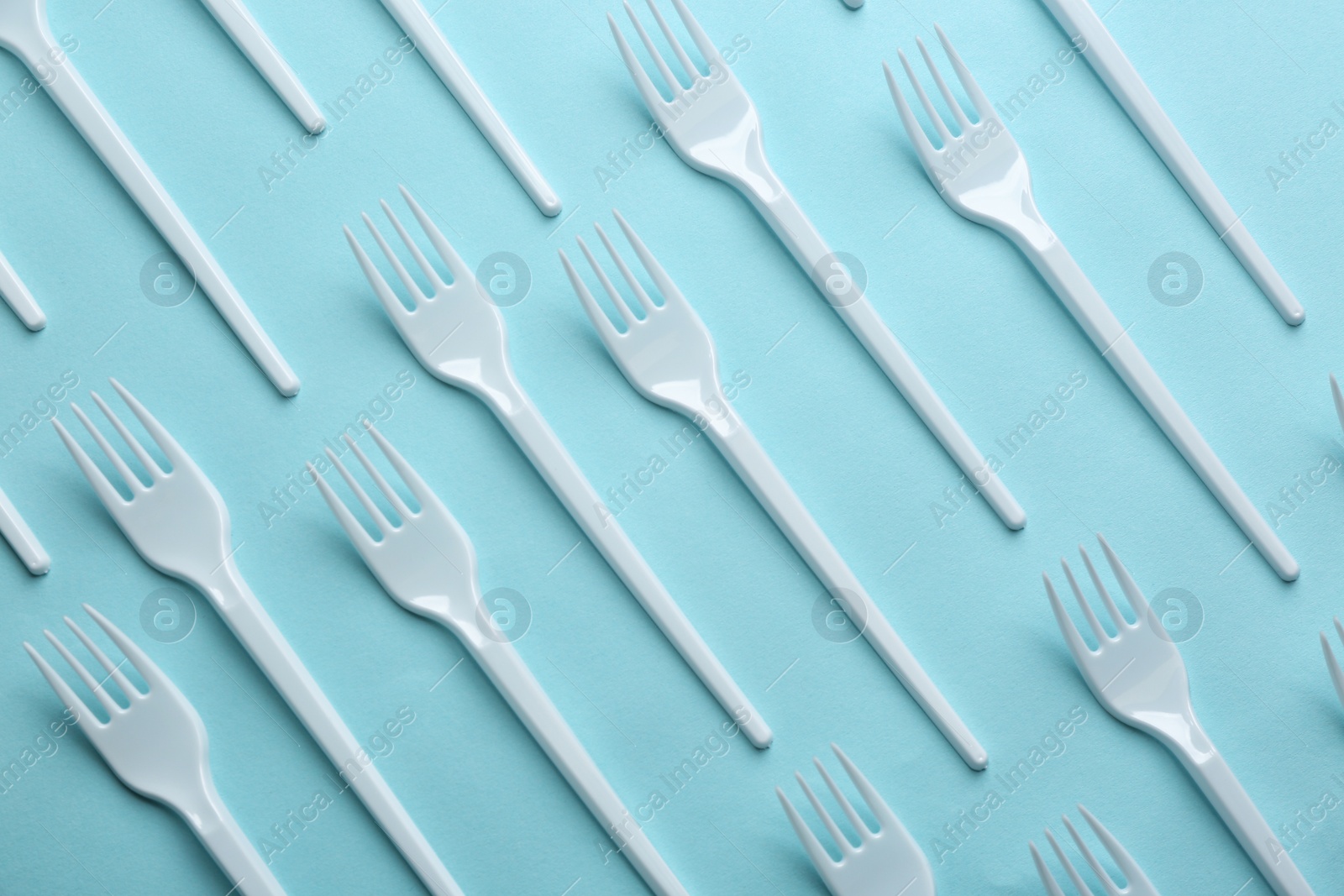 Photo of Flat lay composition with plastic forks on color background. Table setting