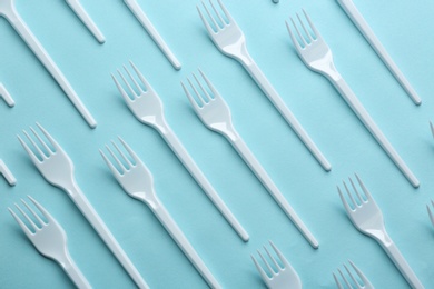 Photo of Flat lay composition with plastic forks on color background. Table setting