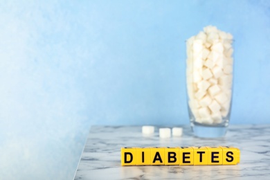 Photo of Word DIABETES made of cubes on table