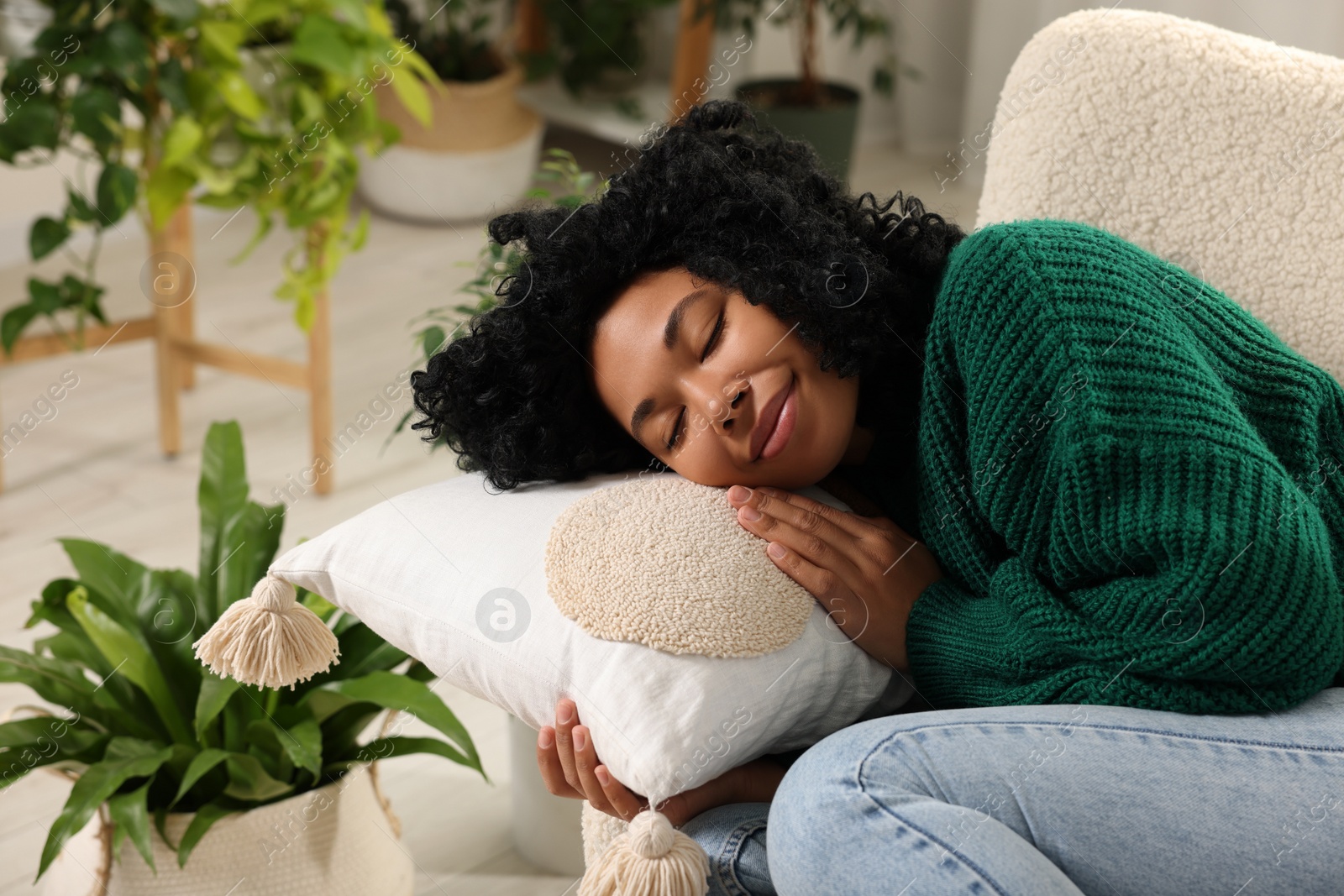 Photo of Relaxing atmosphere. Woman sleeping near beautiful houseplants indoors