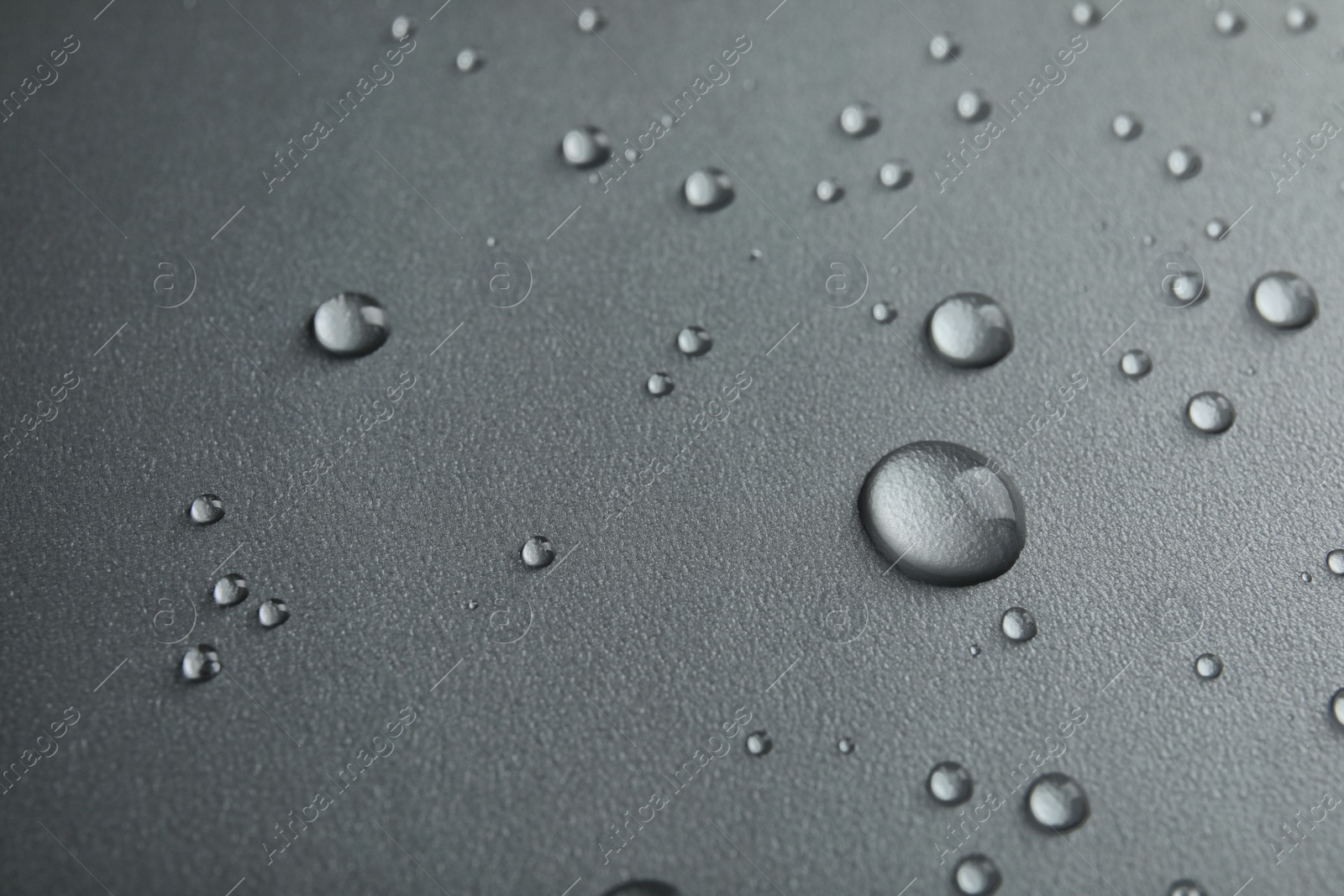 Photo of Many clean water drops on grey background