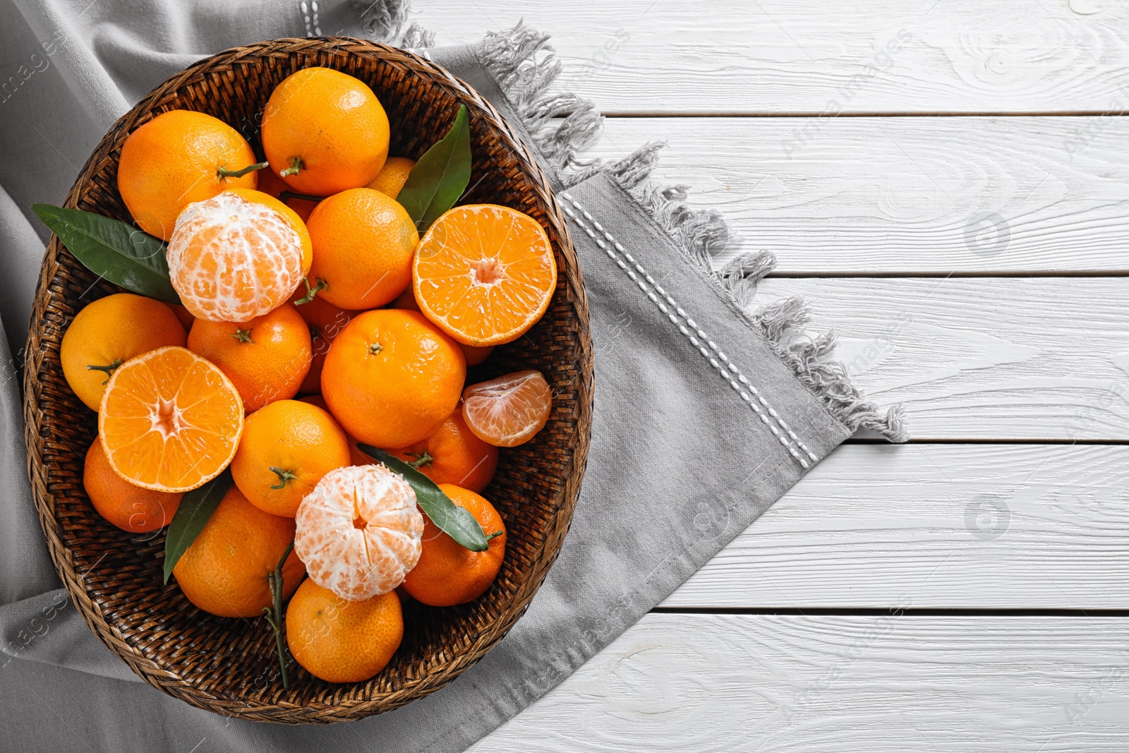 Photo of Fresh ripe tangerines on white wooden table, top view