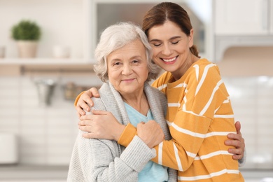 Photo of Elderly woman with female caregiver in kitchen