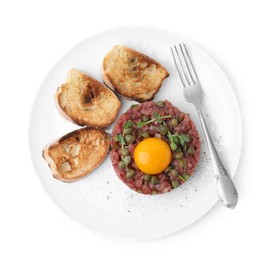 Photo of Tasty beef steak tartare served with yolk, capers, toasted bread and greens isolated on white, top view