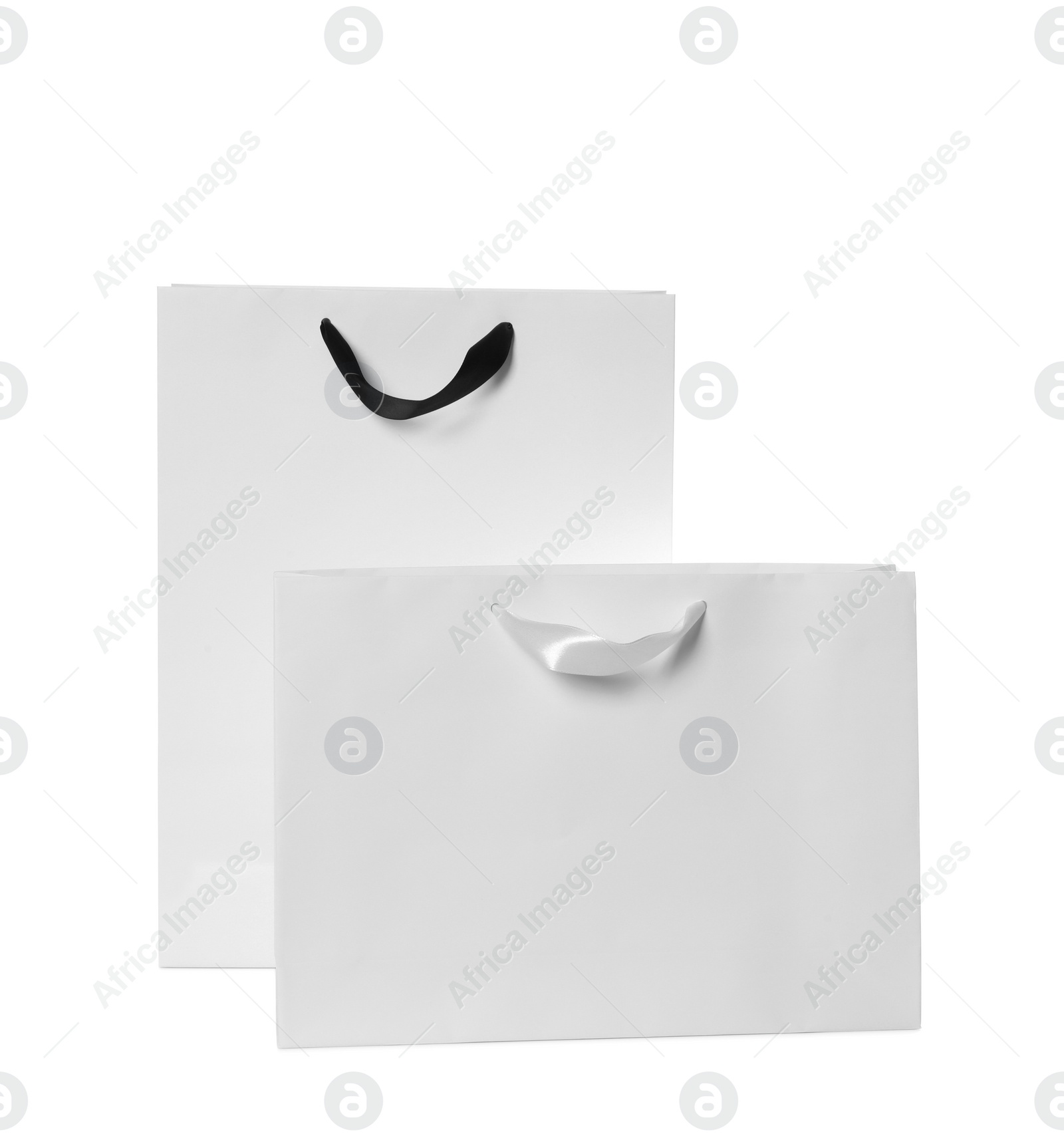 Photo of Paper shopping bags isolated on white. Mock up for design