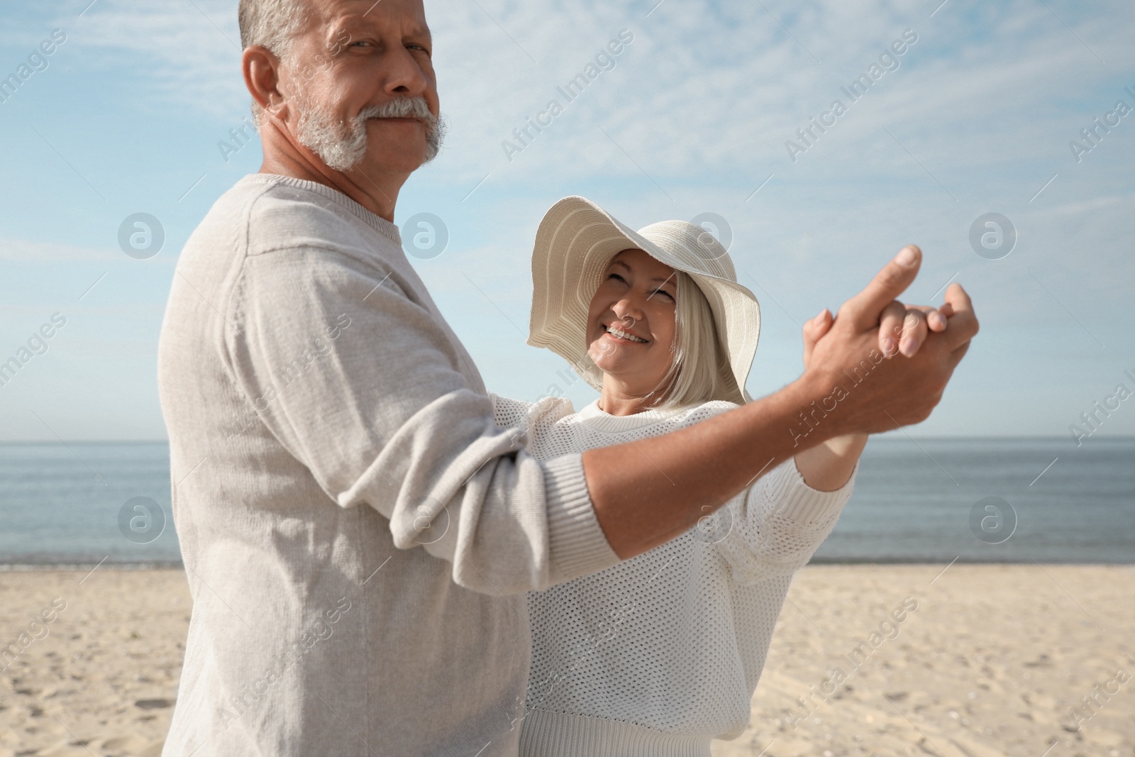 Photo of Mature couple spending time together on sea beach